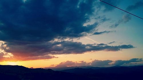 Scenic view of mountains against cloudy sky