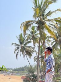 Rear view of woman standing at beach