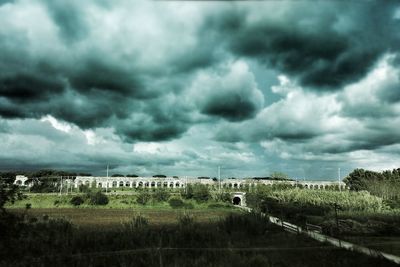 Scenic view of field against cloudy sky