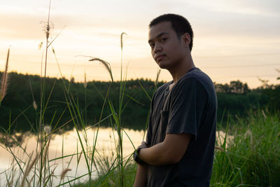 Young man looking away on field