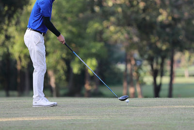 Low section of man playing golf