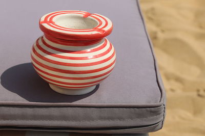 Close-up of striped container on seat