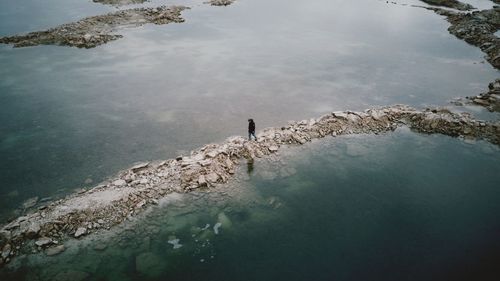 High angle view of reflection of rocks in sea