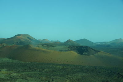 Scenic view of mountains against clear blue sky