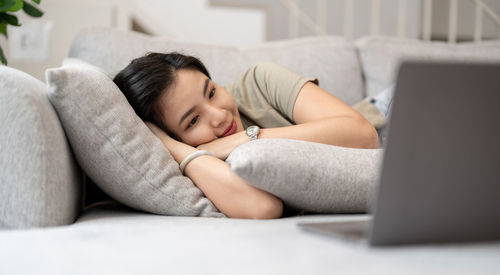 Young woman sleeping on bed at home