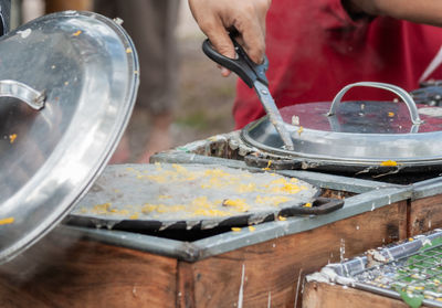 Cropped hand of man preparing food