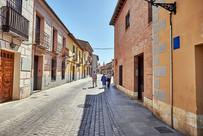 Rear view of people walking on street