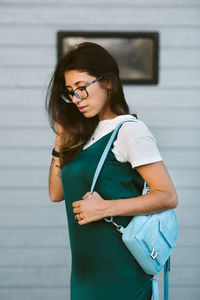 Beautiful woman standing against wall