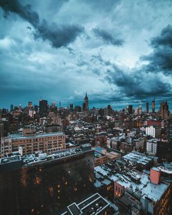 Cityscape against cloudy sky