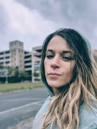 Portrait of beautiful woman against sky