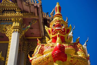 Low angle view of statue against temple building