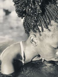 Close-up of girl with braided hair in sea