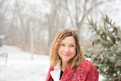 Portrait of smiling woman in snow