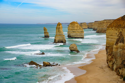 Scenic view of rocks in sea against sky