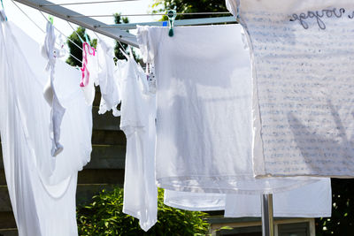 White fabrics drying on clotheslines