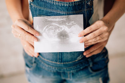 Midsection of woman holding hands