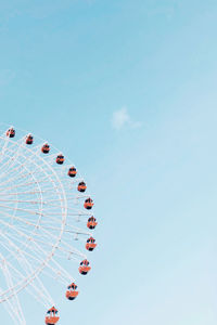 Low angle view of ferris wheel against sky