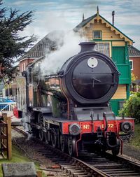 Train on railroad track against sky