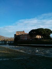 Built structure against blue sky and clouds