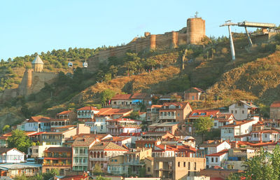 Buildings in town against clear sky