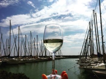 Close-up of beer in sea against sky