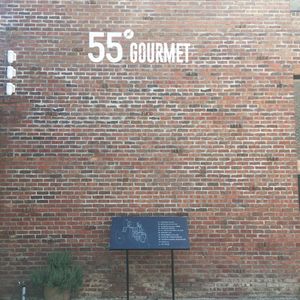 Close-up of signboard against brick wall