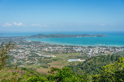 High angle view of buildings and sea against sky