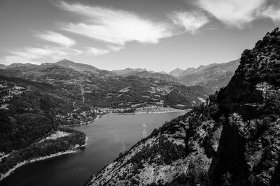 Scenic view of river and mountains against sky