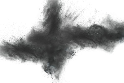 Close-up of exploding dust against white background