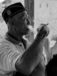 Side view of man smoking cigarette