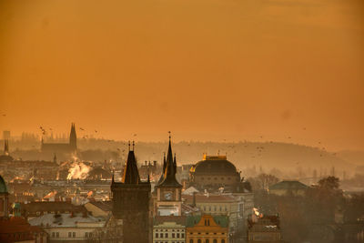 Prague silhouette at morning sunrise with red sky and chimney smoke