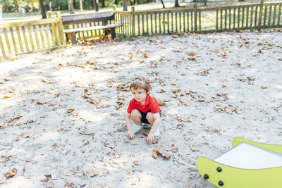High angle view of boy playing with umbrella