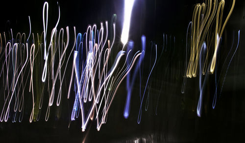 Close-up of illuminated lights against black background