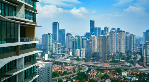 Aerial view of modern buildings in city against sky