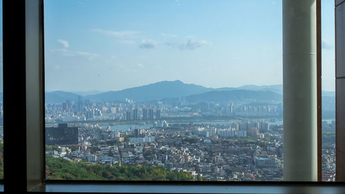 Cityscape against sky seen through window