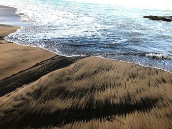 High angle view of waves rushing towards shore