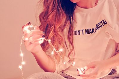 Woman holding christmas lights