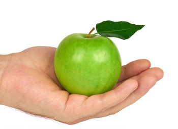 Cropped image of person holding apple against white background