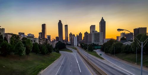 Panoramic view of city buildings against sky during sunset