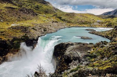 Scenic view of waterfall against sky