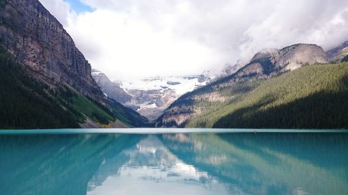 Scenic view of lake and mountains against sky