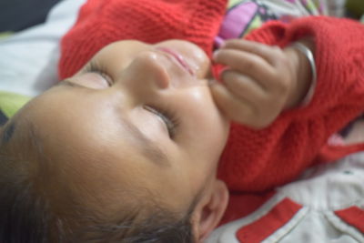 Close-up of baby boy sleeping in bed
