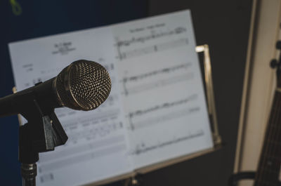 Close-up of microphone with musical note in background