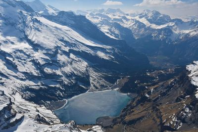 Aerial view of snowcapped mountains against sky