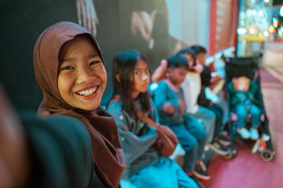 Portrait of young woman wearing hat
