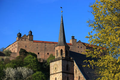 Low angle view of historic building against clear blue sky