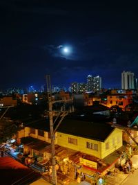 Illuminated cityscape against sky at night