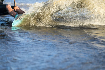 Waist-down male athlete kiteboarding in la ventana, mexico