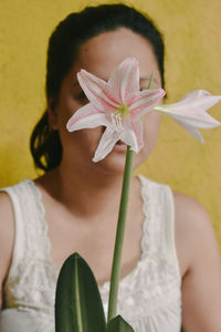 Close-up of woman holding yellow rose flower