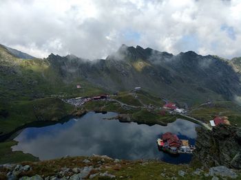 Scenic view of lake and mountains against sky